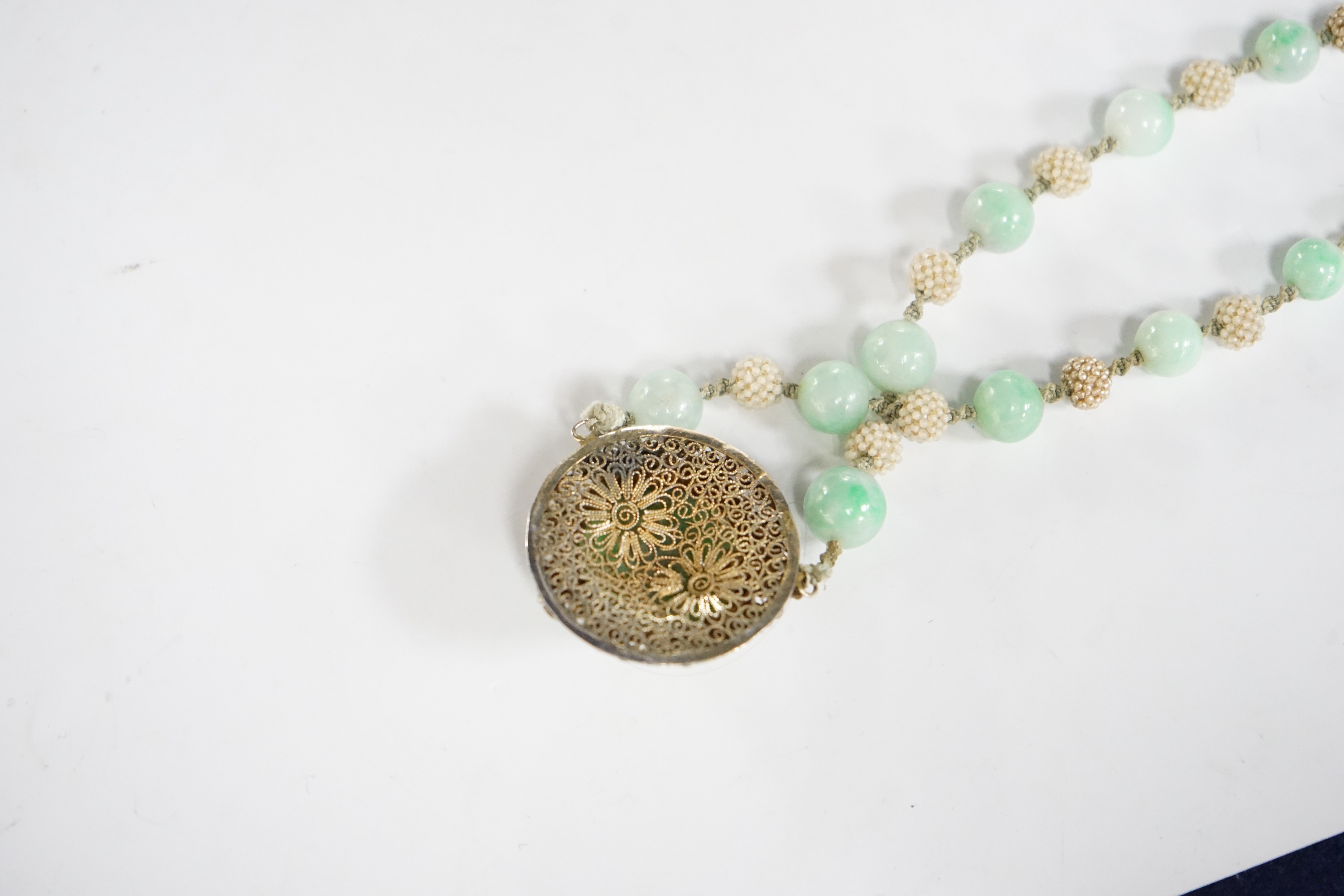 A Chinese late Qing jadeite and seed pearl choker necklace, carved jadeite and silver gilt pendant, 36cm